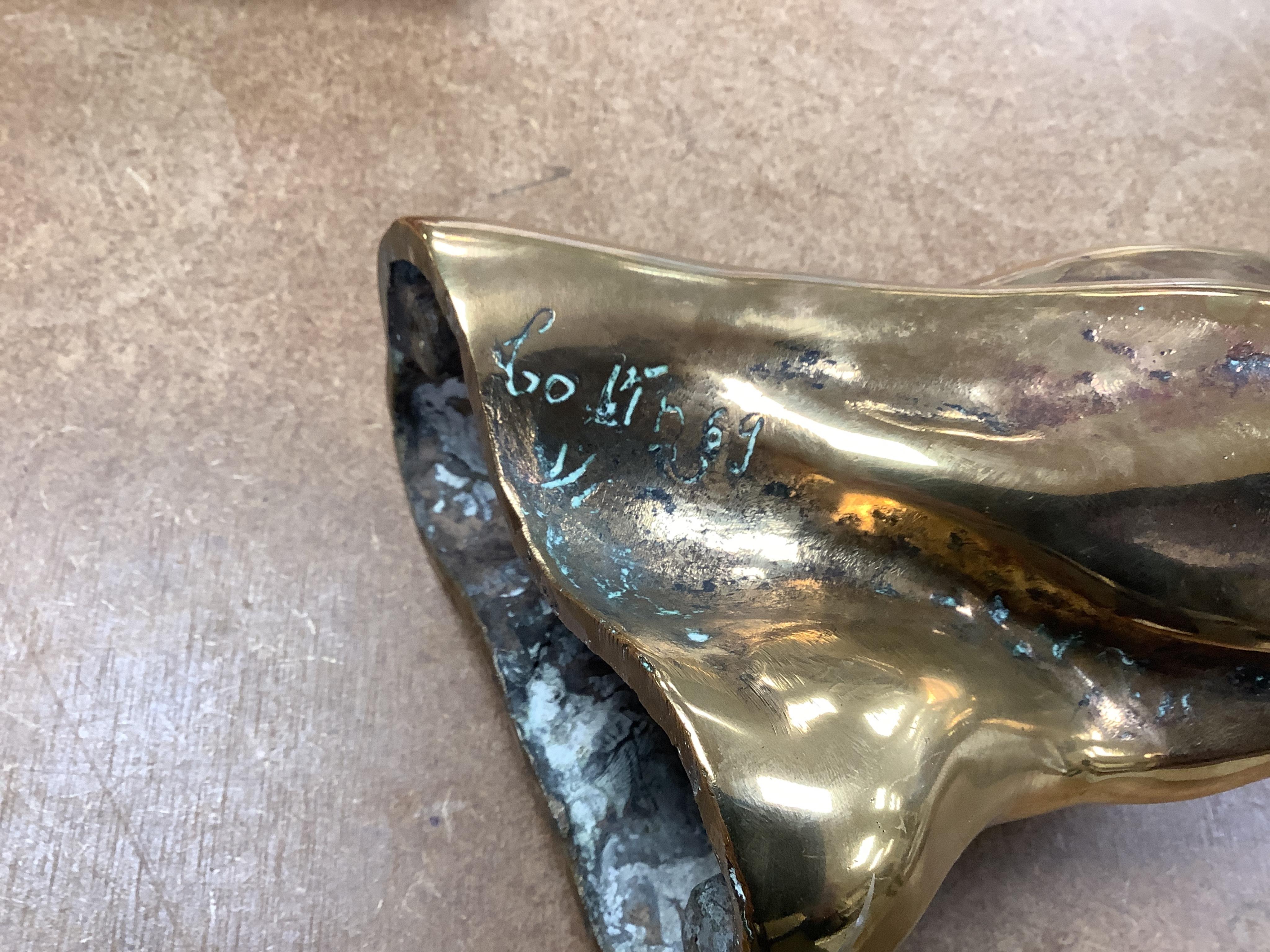 A modernist polished bronze sculpture, two entwined figures, indistinctly signed, 23cm high